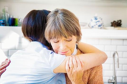 Two women hugging and comforting each other